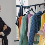 Two women browsing colorful clothing racks in a modern boutique.